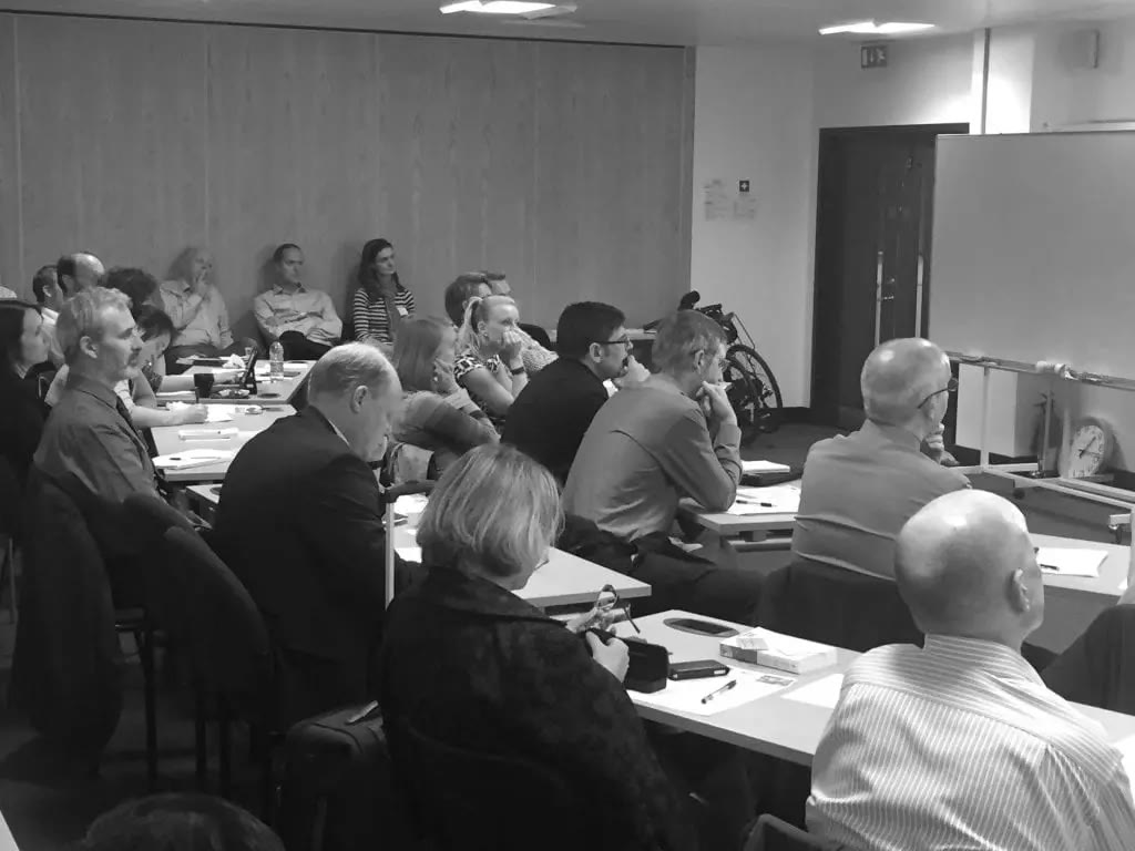 A Heat Academy seminar with participants around tables
